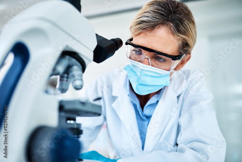 Mature woman, scientist and microscope with study in science lab for medical research or innovation. Female person, tech and face mask in pharmaceuticals, chemistry or biology for vaccine or progress