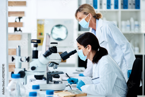 Women, scientist and microscope for medical research, innovation or analysis in science lab. Female people, technology and pathology in pharmaceutical, chemistry or biology for vaccine, career or phd photo