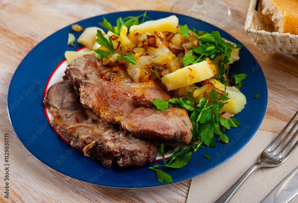 Grilled pork chop steak on plate served with boiled potatoes Grilled pork chop steak on plate served with boiled potatoes
