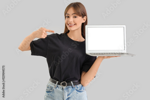 Young woman pointing at bla...