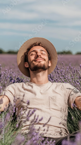 Relaxed man enjoying sunny day in lavender field with eyes shut