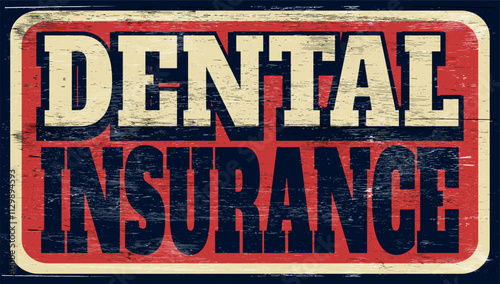 Aged retro dental insurance sign on wood