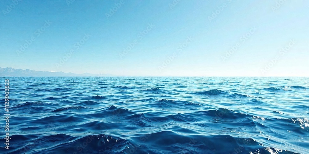 Fototapeta premium Ruffled blue ocean surface reflecting a clear sky, ripple effects, undulating waves