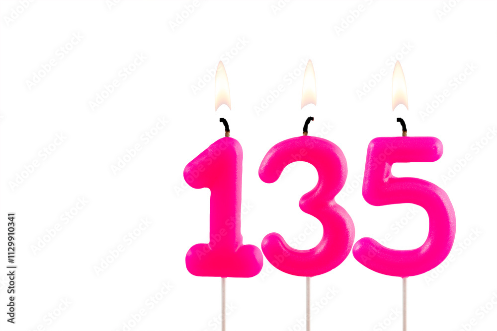 Pink number 135 birthday candle lit on white background Pink number 135 birthday candle lit on white background