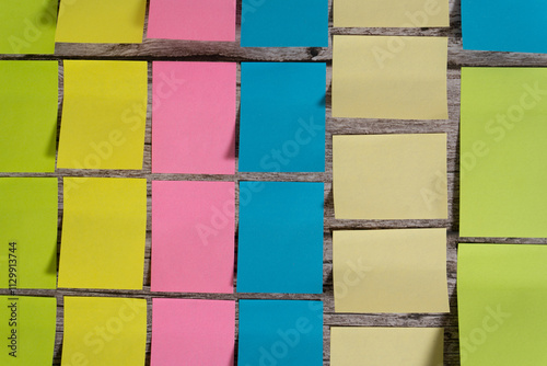 Post-it notes and sticky notes sorted by color and size on a table