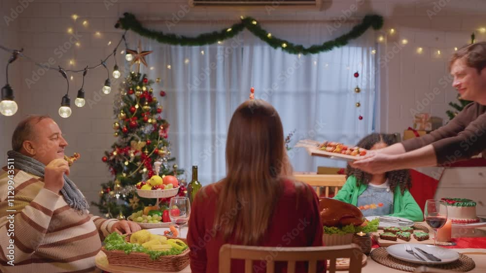 Multiracial lovely family celebrating Christmas party together in house. Multiracial lovely family celebrating Christmas party together in house.