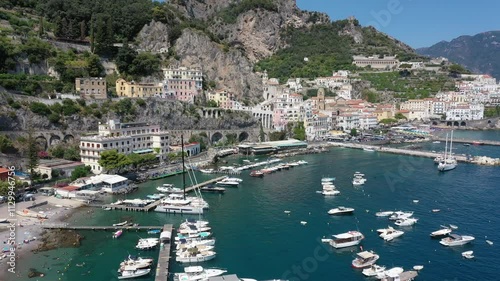 Aerial view of Amalfi town center, coast, sea and boats in marina on a sunny summer day, Italy