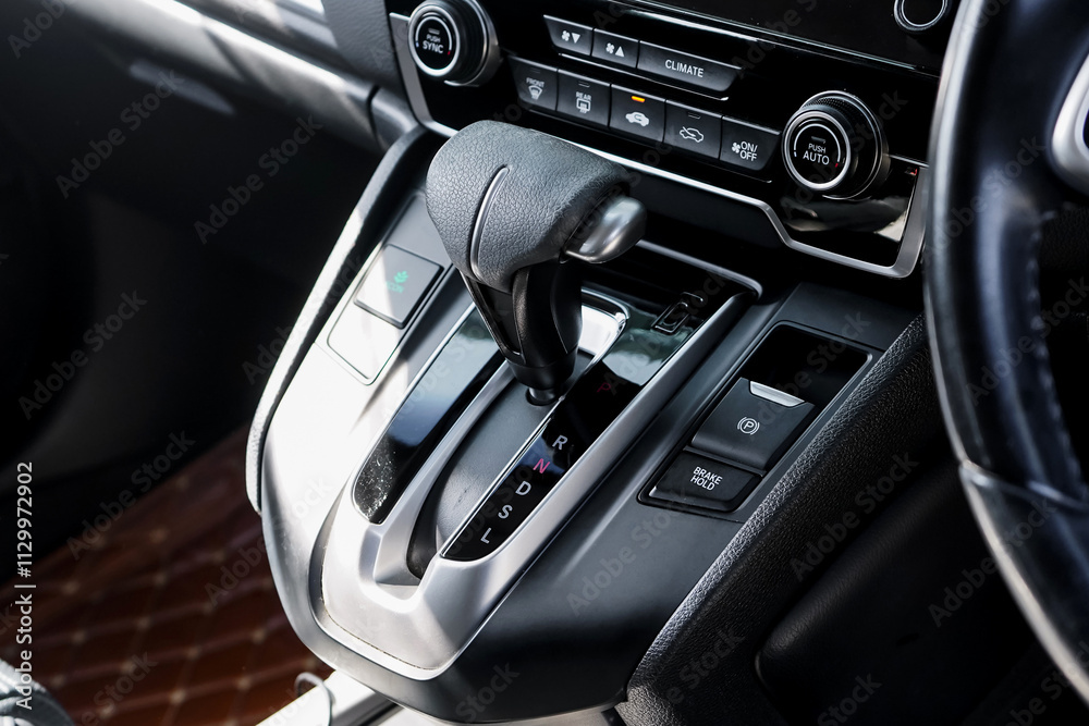automatic transmission shift selector in the car interior. Closeup a manual shift of modern car gear shifter. 4x4 gear shift automatic transmission shift selector in the car interior. Closeup a manual shift of modern car gear shifter. 4x4 gear shift