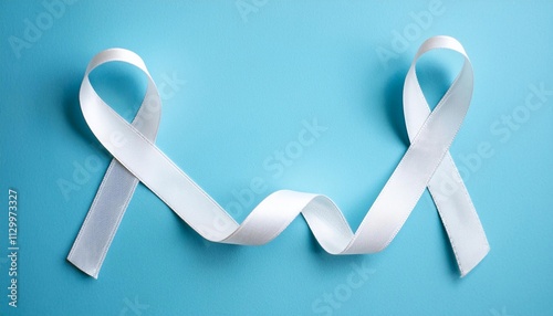 Lung Cancer Awareness Symbol. White Ribbon with Copy Space for Text. Light Blue Background Isolated. Flat Lay Top View. photo