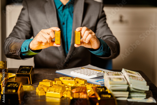 A businessman sits at his desk in a nighttime office, using a laptop to analyze gold bar prices,exchange rates, and investment plans in gold trading, mining,and the stock market amid price increases photo