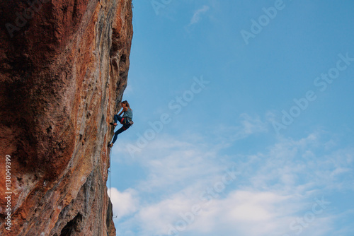 rock climber girl. rock climber girl climbs an overhanging rock.