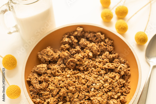 Bowl with morning cereal granola and a glass of milk photo