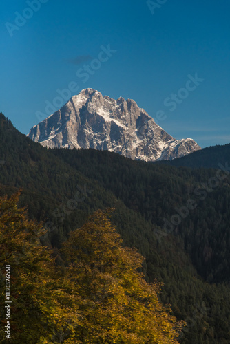 Il monte Pelmo visto da Colcerver, borgo della Val di Zoldo nelle Dolomiti bellunesi, in una giornata autunnale con il foliage degli alberi photo