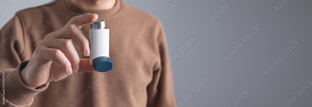 Fototapeta premium Caucasian man with a asthma inhaler. Concept of treatment of bronchial asthma