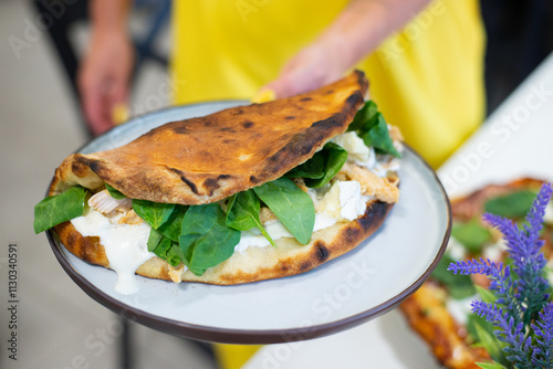 Opened opne calzone italian pizza with cheese in plate homemade in Lithuania photo