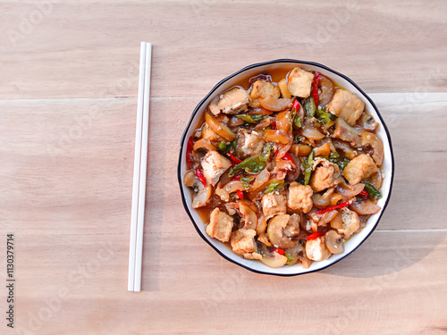 stir-fried knuckle or trotter with tofu served with plate on wooden background. chewy and soft dish. asian cuisine. oseng tahu kikil photo