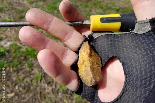 Flint point covered with yellow patina found on the ground, Stone Age artifact. Russia photo