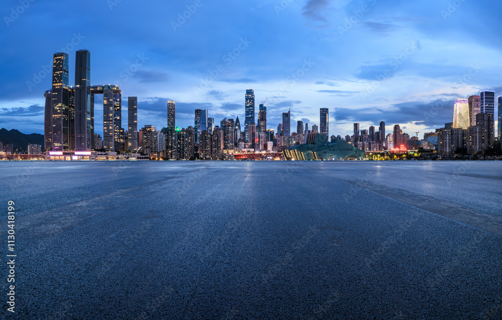 Asphalt road square and city skyline with modern buildings scenery at night in Chongqing, China. Outdoor asphalt parking lot.