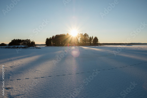 Snow-covered landscape in Leksand, Dalarna, illuminated by winter sun