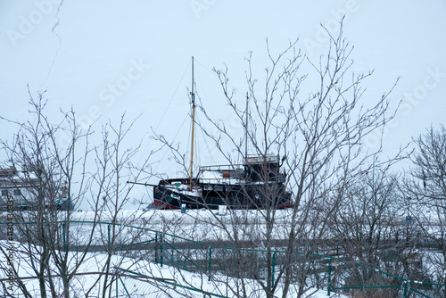 Winter landscape with a boat in Stockholm, Sweden covered in snow