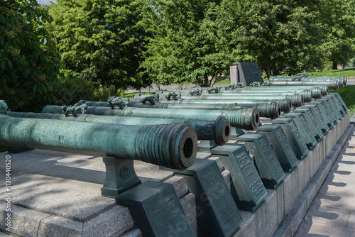 Ancient cannons are installed on territory of Moscow Kremlin. Guns are made of copper. Color of gun barrels is green. Clear sunny summer day. Moscow, Russia – June 14, 2024