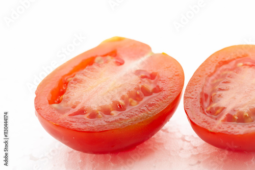 Two tomato slices are cut in half