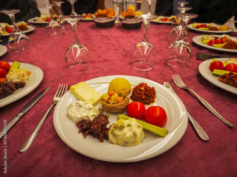Hors d'oeuvre plate, white cheese, tomatoes, cucumber, haydari, Russian salad, pistachio paste, fava, artichoke with olive oil.