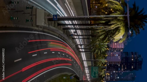 Panoramic view of urban traffic in Barcelona at dusk.Smooth camera movement: Zoom out.
Transit in the round of the littoral with the modern skyscrapers of the technology district 22@ on background.