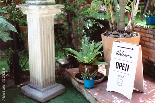 Open and welcome sign placed at the entrance of the cafe shop