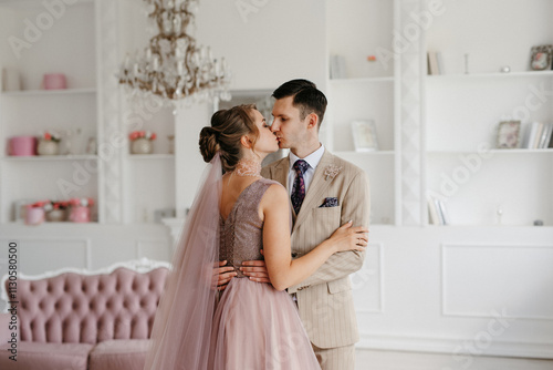 groom in beige suit and bride in lavender wedding tight dress photo