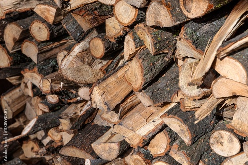 Stacked Firewood Close-Up with Sunlight on Wooden Logs – Rustic Natural Texture