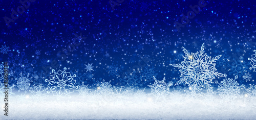 Merry Christmas background with white snowflakes isolated on blue.