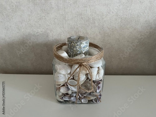 Decorative Glass Jar with Seashells and Candle for Home Decoration photo