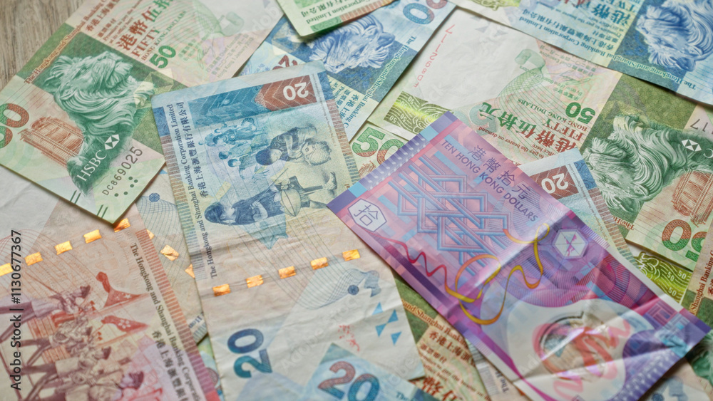 Fototapeta premium Scattered hong kong dollar banknotes showcasing colorful currency design in a close-up view with no people in the scene