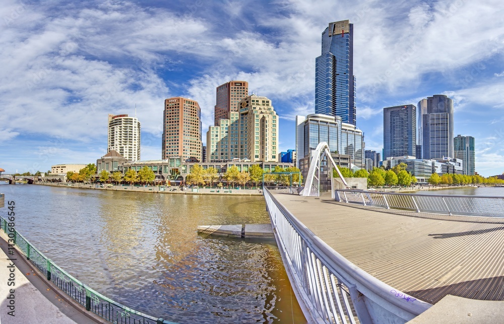 Naklejka premium Yarra River and Melbourne skyline, blending architecture and nature in harmony