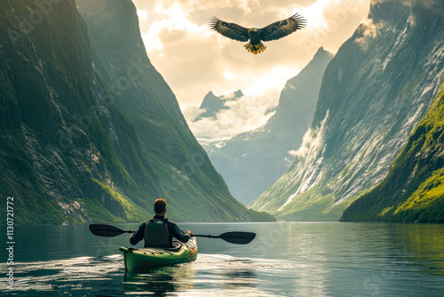 Scenic adventure: man kayaking through majestic mountains with soaring eagle