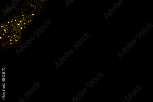 Golden blurred bokeh lights on black background. Glitter sparkle stars for celebrate. Overlay for your design