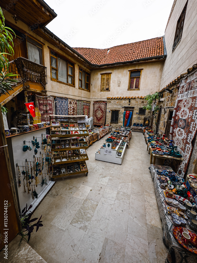 Fototapeta premium shopping in the Bazar, handmade pillows, bags and carpets are on the wall for sale. The sunlight comes to inside from roof window.