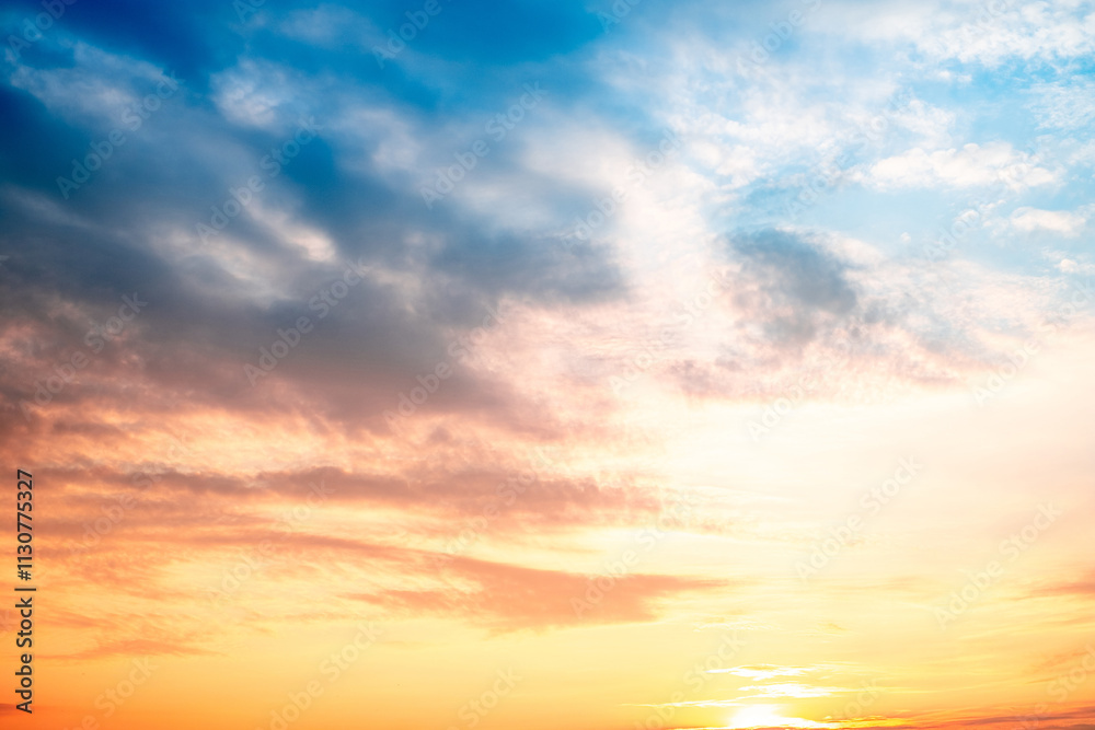 Obraz premium Sky,sunset, beautiful , luxury soft gradient orange gold clouds and sunlight on the blue sky perfect for the background, Sunrise on morning or everning in winter warm time ,Twilight summer,silhouette