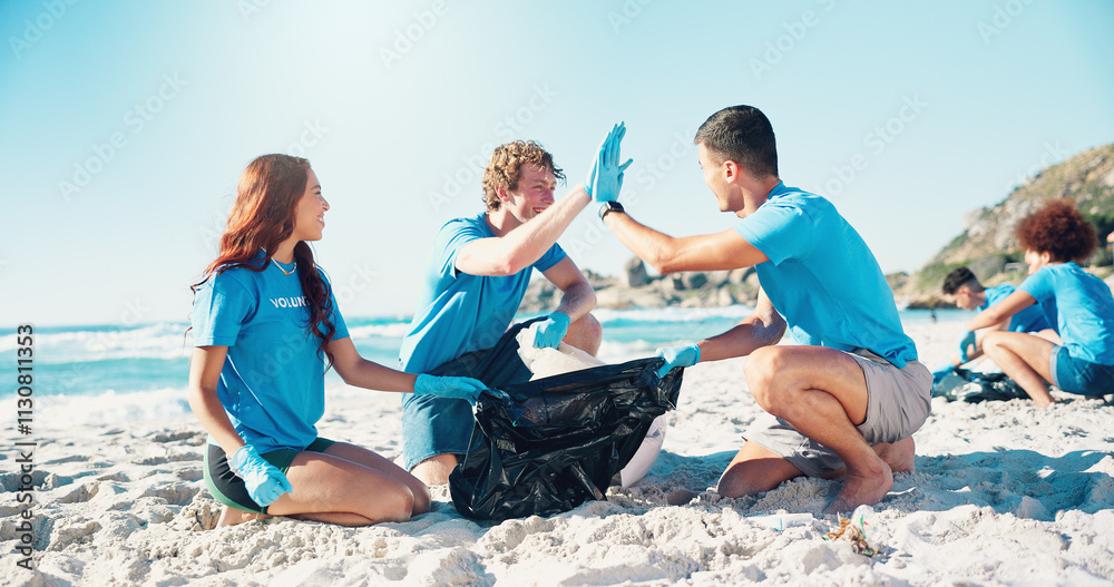 Obraz premium Beach, volunteer and group of people with high five for support, motivation and community service. Climate change, pollution and recycling team with ocean clean up, success and social responsibility