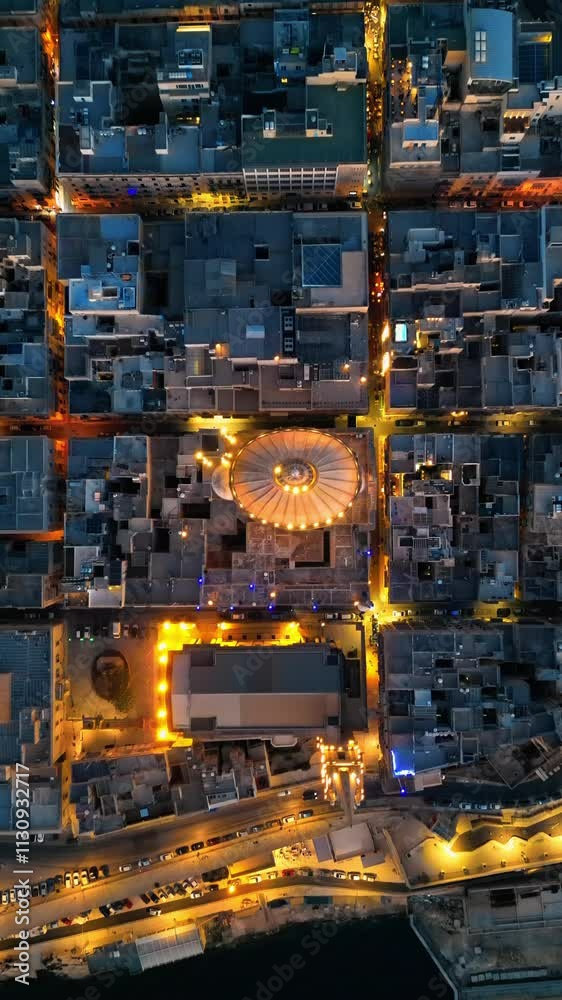 Aerial drone view of the walled city of Valletta, Malta, surrounded by the Mediterranean sea in the evening. Vertical Aerial drone view of the walled city of Valletta, Malta, surrounded by the Mediterranean sea in the evening. Vertical