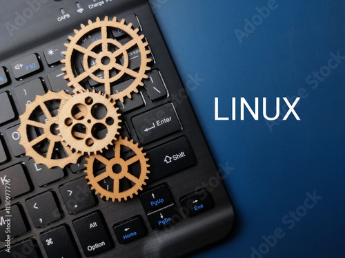 Foto Wooden gear and keyboard with the word LINUX on blue background