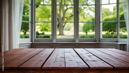 Empty wood table top and blurred of interior room with window view from green tree garden background background - can used for display or montage your products.