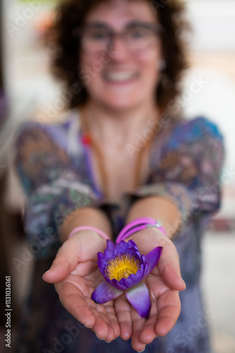 Woman showing purple water lily in sri lanka