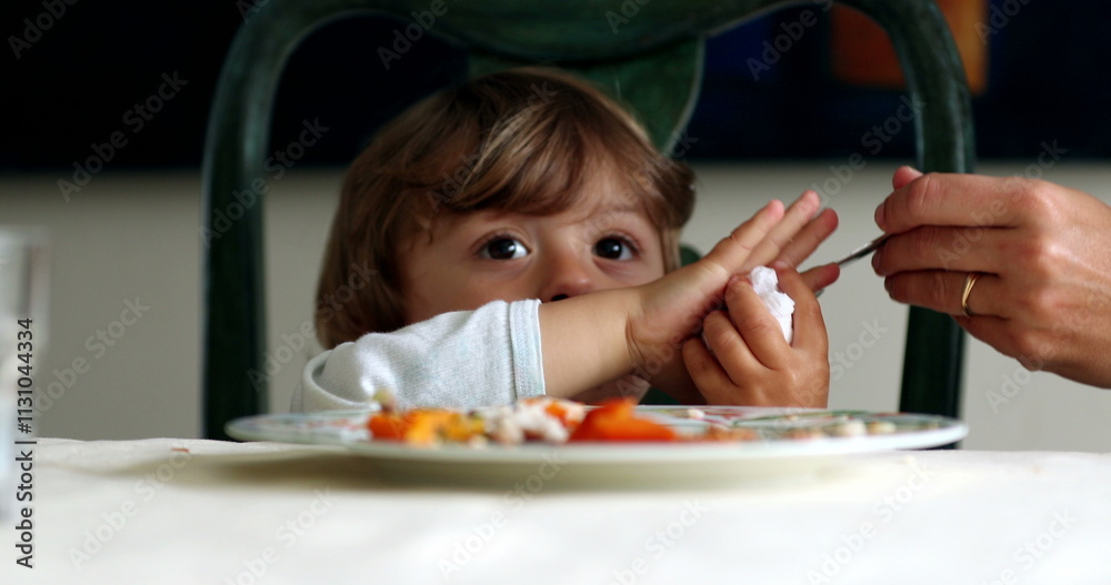 Child wiping hand with napkin. little boy at lunch cleans hand wipes Child wiping hand with napkin. little boy at lunch cleans hand wipes