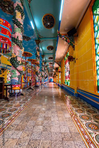 Cao Dai temple area and meditating followers of the Cao Dai religion in the temple Cao Dai, Tay Ninh, Vietnam photo