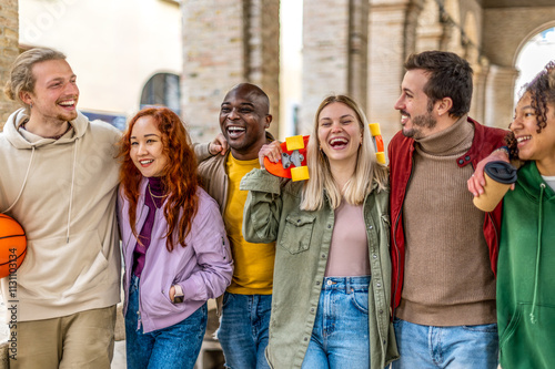Canvas Print Happy multiracial group of friends walking hug on city street - Cheerful young p
