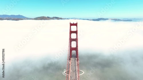 Forward push-in shot over the fog shrouded Golden Gate Bridge in San Francisco, Ca.