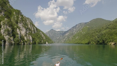 Aerial view on beautiful mountain lake surrounded with forest and mountains