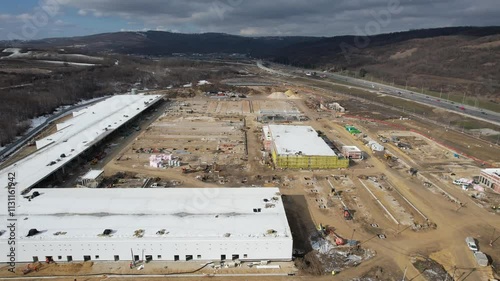 Aerial view on huge construction site with heavy equipment and workers.